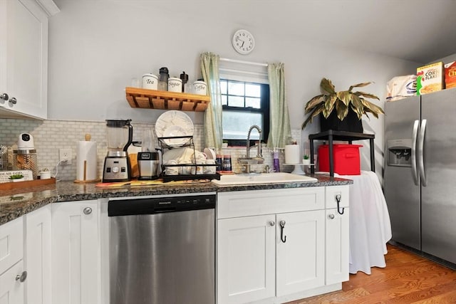 99 Lincoln St, Stoughton, MA 02072 - kitchen with appliances with stainless steel finishes, a sink, open shelves, decorative backsplash, and white cabinetry