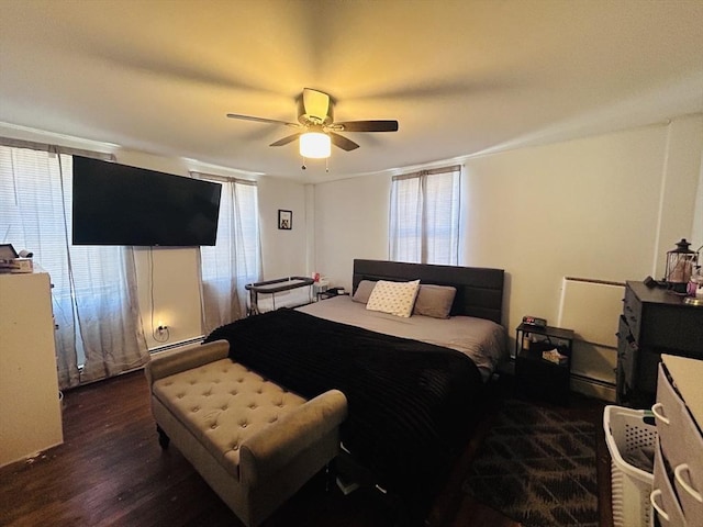 bedroom featuring dark hardwood / wood-style floors, ceiling fan, and baseboard heating