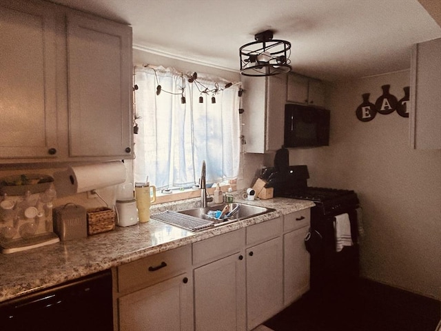 kitchen with light stone countertops, sink, white cabinets, and black appliances