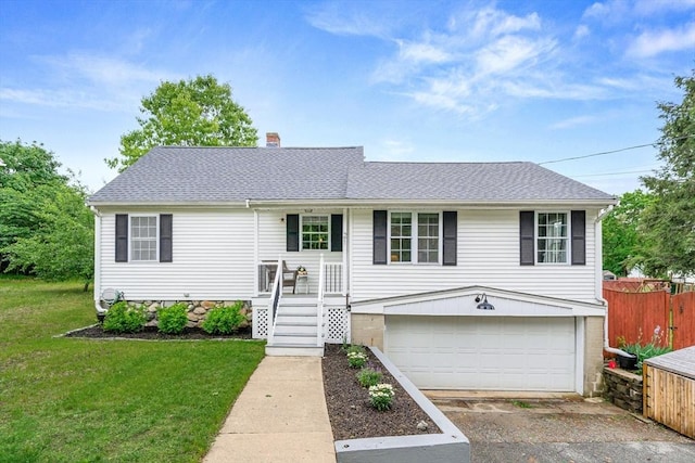 21 Forest St, Wilmington, MA 01887 - split foyer home with asphalt driveway, a garage, a chimney, and roof with shingles