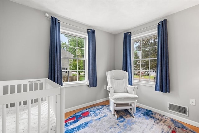 21 Forest St, Wilmington, MA 01887 - bedroom with baseboards, wood finished floors, and a nursery area