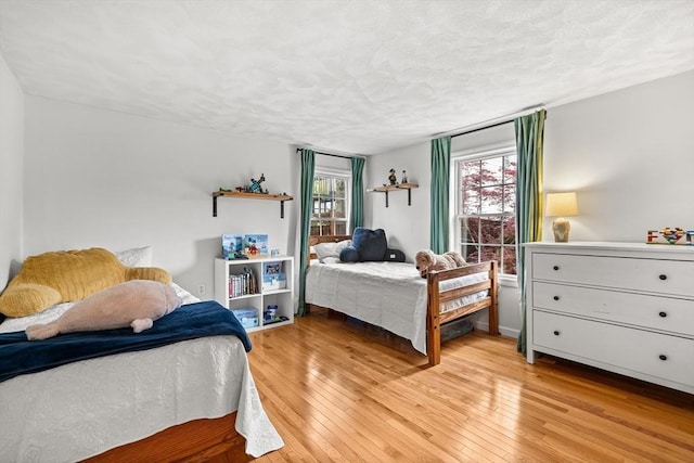 21 Forest St, Wilmington, MA 01887 - bedroom with light wood-style flooring and a textured ceiling