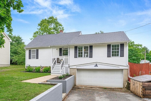 21 Forest St, Wilmington, MA 01887 - view of front of property featuring an attached garage, a front lawn, driveway, and a chimney