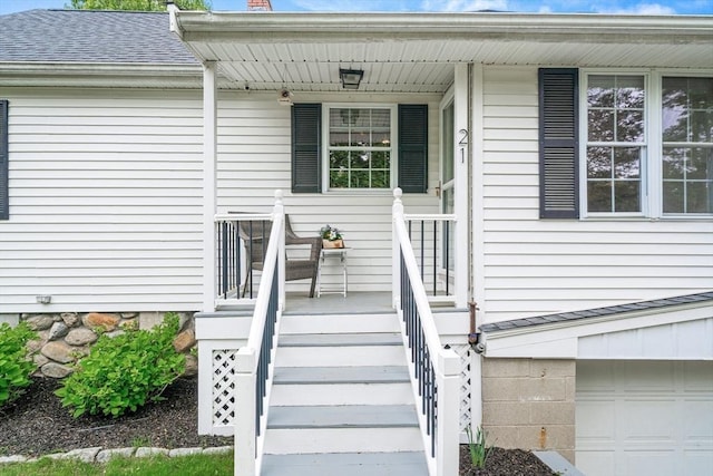 21 Forest St, Wilmington, MA 01887 - doorway to property featuring a porch, an attached garage, roof with shingles, and a chimney