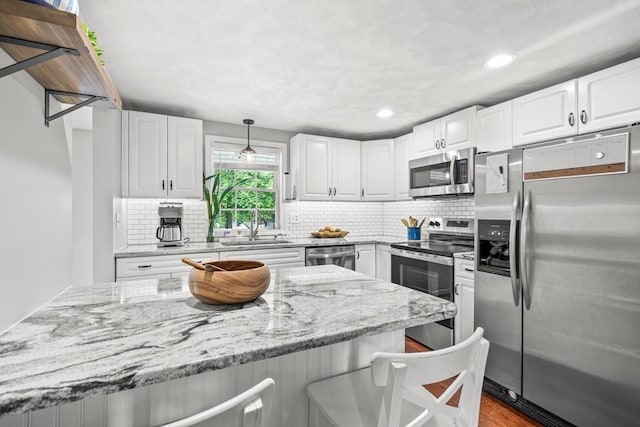 21 Forest St, Wilmington, MA 01887 - kitchen featuring appliances with stainless steel finishes, a sink, backsplash, white cabinets, and recessed lighting