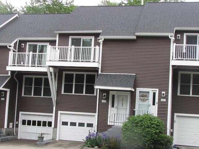 101 S Ave Unit 202, Attleboro, MA 02703 - view of property with an attached garage, a balcony, and roof with shingles