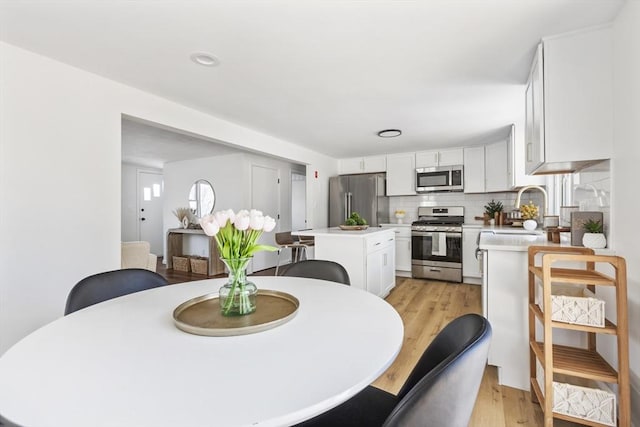 dining room with light wood-style flooring