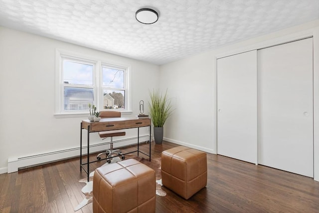 office area with baseboards, a baseboard heating unit, and dark wood-style flooring