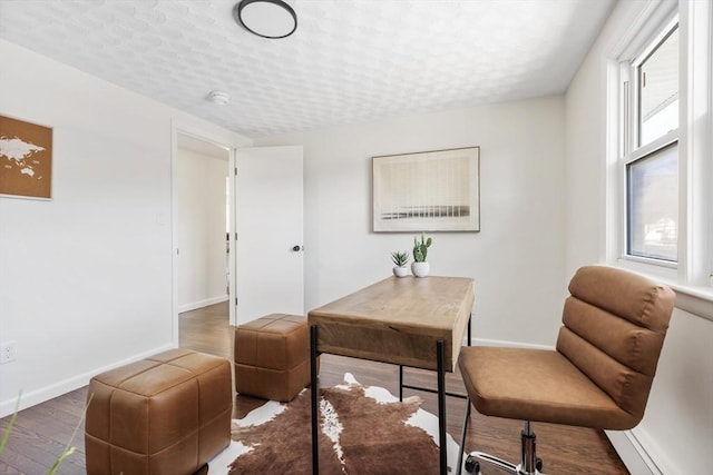 office space with a textured ceiling, dark wood finished floors, and baseboards