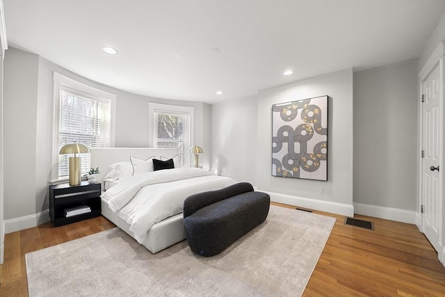 bedroom with hardwood / wood-style floors