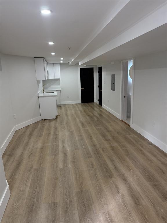 567 Park St Unit 1And B, Boston, MA 02124 - unfurnished living room featuring light wood-style flooring, baseboards, recessed lighting, and electric panel