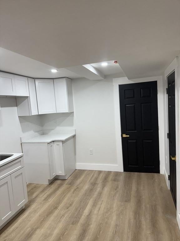 567 Park St Unit 1And B, Boston, MA 02124 - kitchen with light wood finished floors, white cabinetry, light countertops, and baseboards
