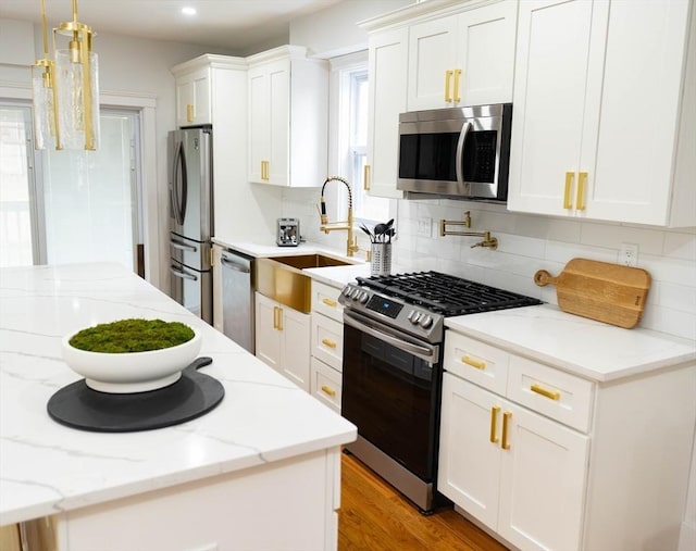 567 Park St Unit 1And B, Boston, MA 02124 - kitchen featuring appliances with stainless steel finishes, a sink, decorative backsplash, white cabinets, and recessed lighting