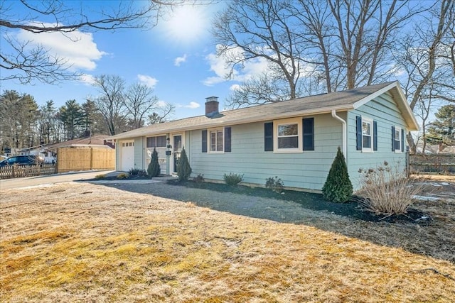 ranch-style home with a garage and a front yard