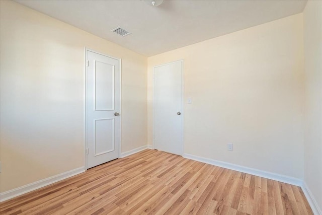 spare room with light wood-type flooring