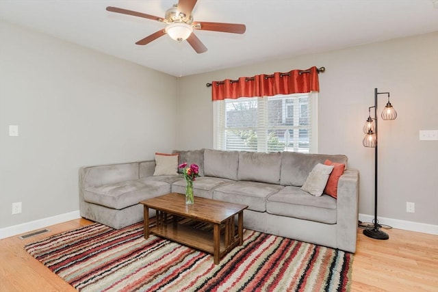 living room featuring ceiling fan and wood-type flooring