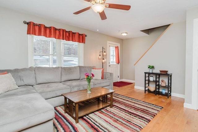 living room with ceiling fan and light hardwood / wood-style floors