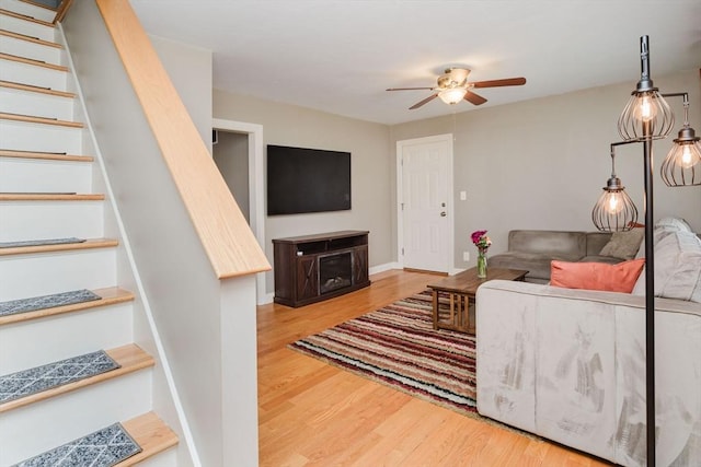 living room with ceiling fan and wood-type flooring