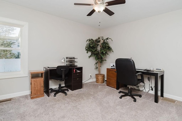 office area with ceiling fan and light carpet