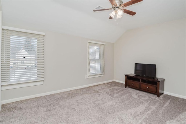 unfurnished bedroom with ceiling fan, light colored carpet, and lofted ceiling