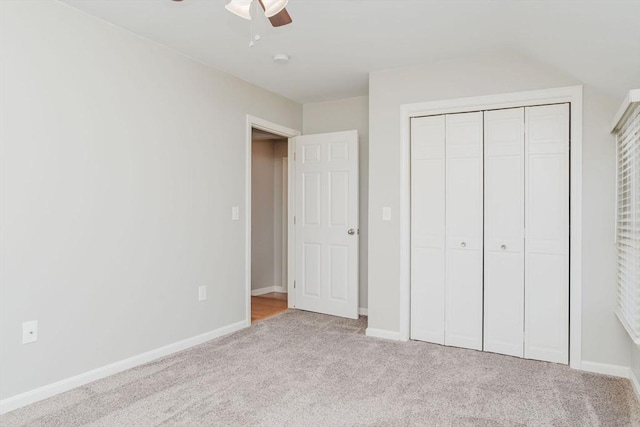 unfurnished bedroom with light carpet, ceiling fan, and a closet