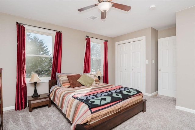 carpeted bedroom with a closet and ceiling fan