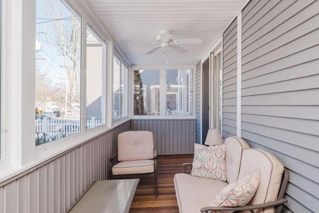 sunroom featuring ceiling fan