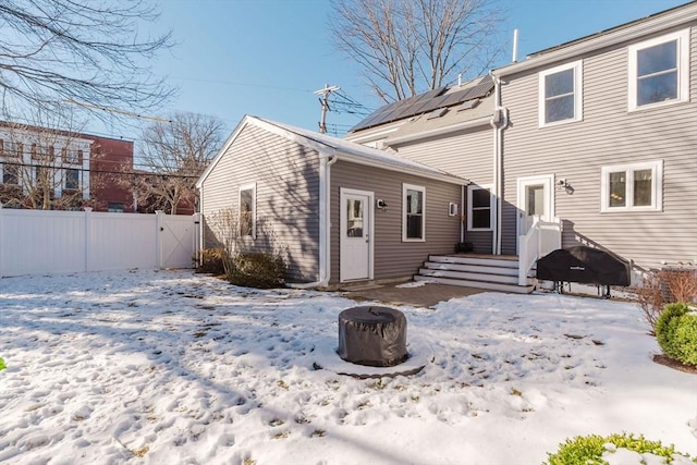 view of snow covered rear of property