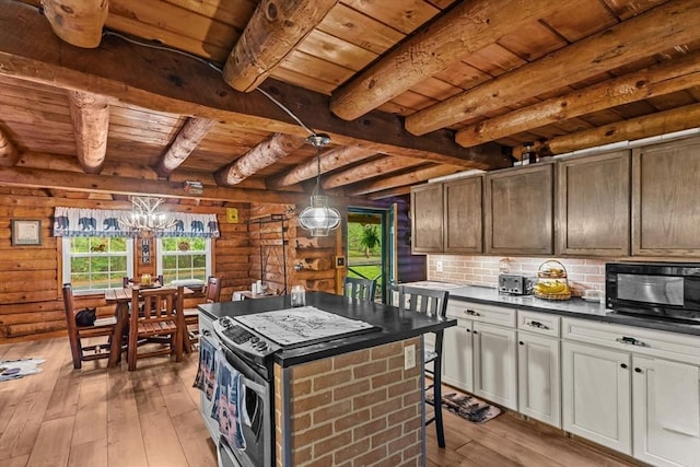 125 Blackstone St, Uxbridge, MA 01569 - kitchen featuring wooden ceiling, dark countertops, light wood finished floors, a chandelier, and beamed ceiling