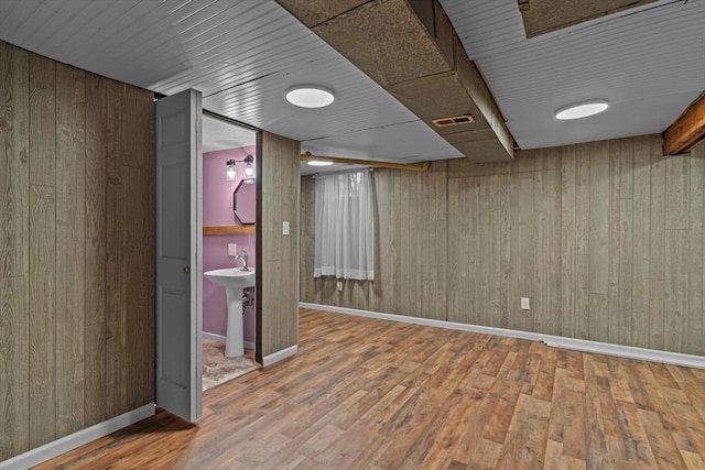 125 Blackstone St, Uxbridge, MA 01569 - finished below grade area with wood walls, wood finished floors, baseboards, and a sink