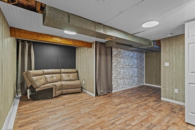 125 Blackstone St, Uxbridge, MA 01569 - finished below grade area with wood finished floors, baseboards, a baseboard heating unit, and wood walls