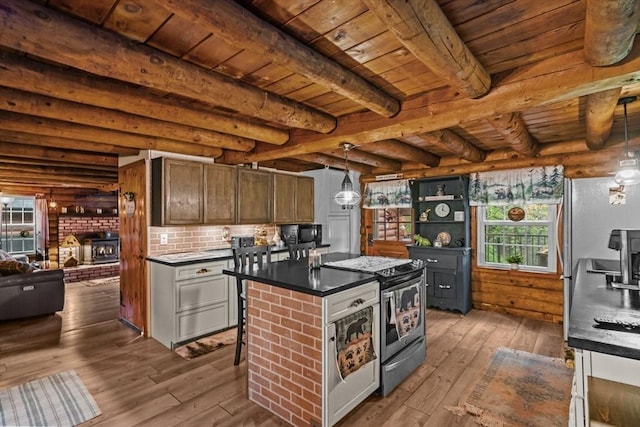 125 Blackstone St, Uxbridge, MA 01569 - kitchen with appliances with stainless steel finishes, wood ceiling, dark countertops, wood-type flooring, and beamed ceiling
