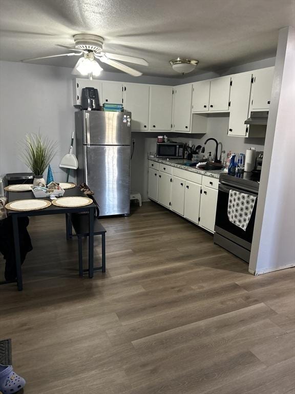 kitchen featuring white cabinets, dark hardwood / wood-style flooring, sink, and appliances with stainless steel finishes