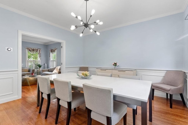 3 Anders Way, Acton, MA 01720 - dining space featuring crown molding, a chandelier, a decorative wall, light wood finished floors, and a wainscoted wall