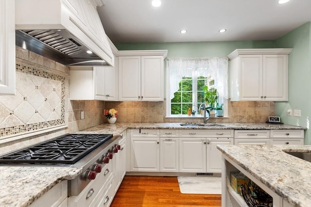 3 Anders Way, Acton, MA 01720 - kitchen with a sink, premium range hood, stainless steel gas cooktop, white cabinets, and light wood-style flooring