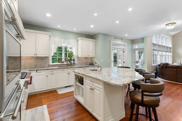3 Anders Way, Acton, MA 01720 - kitchen featuring a sink, a kitchen bar, a center island with sink, plenty of natural light, and recessed lighting