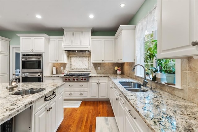 3 Anders Way, Acton, MA 01720 - kitchen with stainless steel appliances, a sink, custom range hood, white cabinets, and recessed lighting