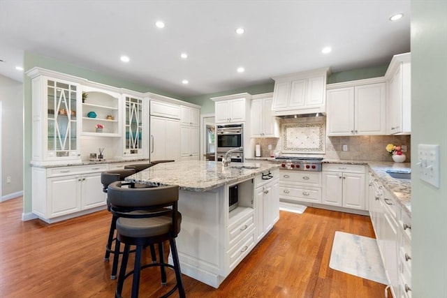 3 Anders Way, Acton, MA 01720 - kitchen with appliances with stainless steel finishes, a sink, open shelves, a kitchen island with sink, and tasteful backsplash