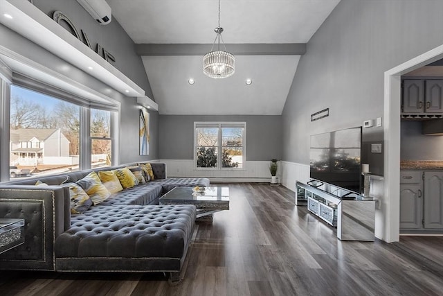 living room with high vaulted ceiling, a healthy amount of sunlight, dark hardwood / wood-style floors, and an inviting chandelier