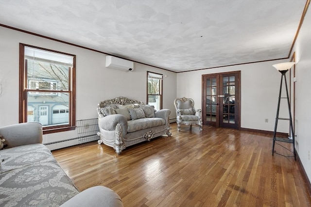 living room with hardwood / wood-style flooring, a baseboard heating unit, french doors, ornamental molding, and an AC wall unit