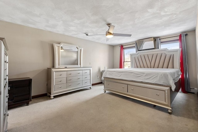 bedroom featuring ceiling fan, light carpet, and a textured ceiling