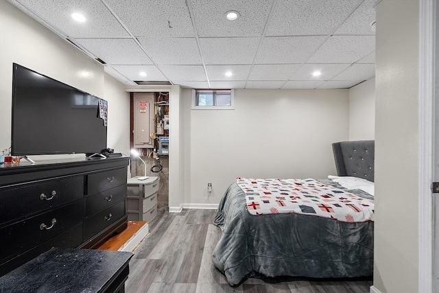 bedroom featuring hardwood / wood-style floors and a paneled ceiling