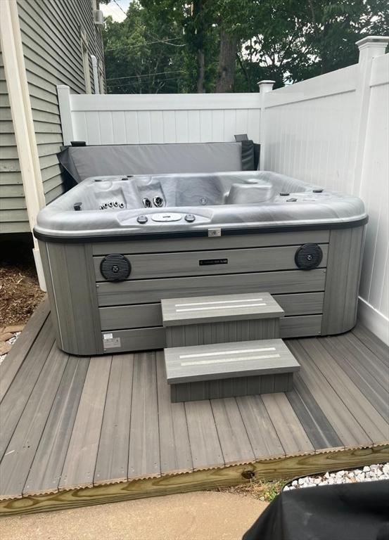 wooden terrace featuring a hot tub