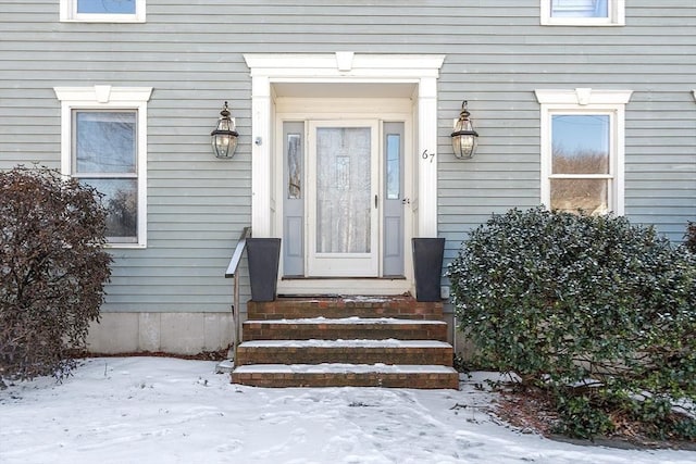 view of snow covered property entrance