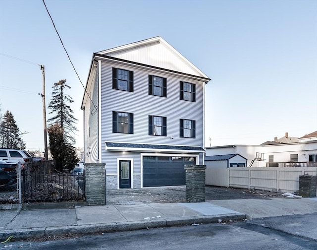 view of front of property with a garage, stone siding, and a fenced front yard