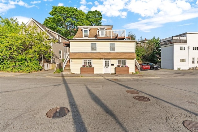 31-33 New Ocean St, Swampscott, MA 01907 - view of front facade with a balcony, stairway, and uncovered parking