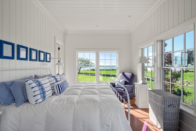 bedroom with wood walls, ornamental molding, and wood-type flooring