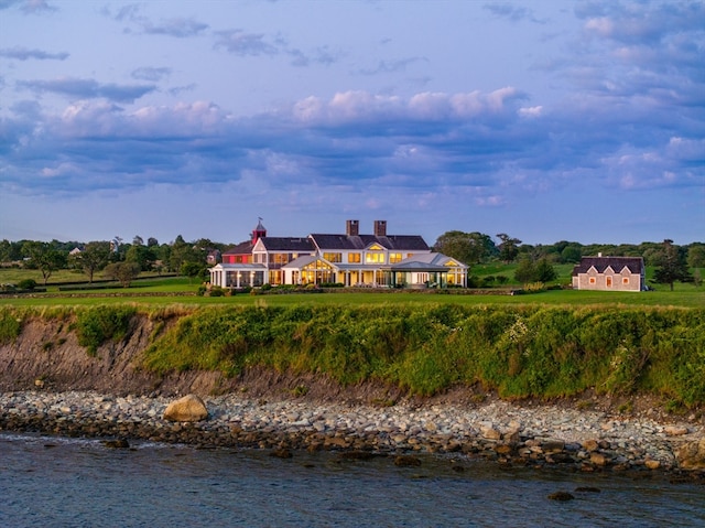 back of property featuring a water view