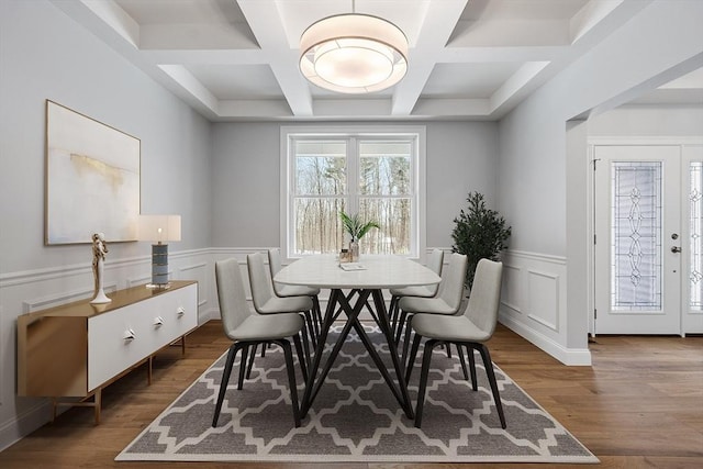 dining room with beamed ceiling, wood-type flooring, and coffered ceiling