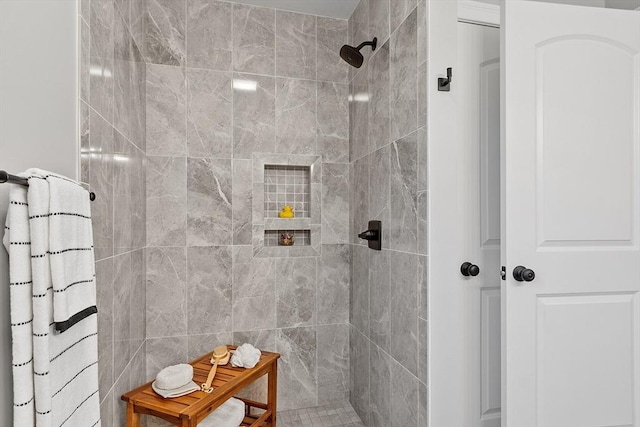 bathroom featuring a tile shower